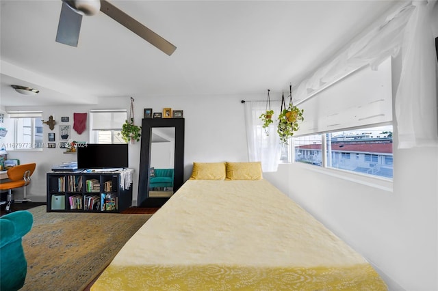 bedroom featuring multiple windows and ceiling fan