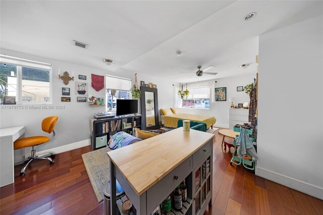 dining space featuring dark wood-type flooring and ceiling fan