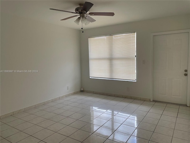 empty room featuring ceiling fan and light tile patterned floors