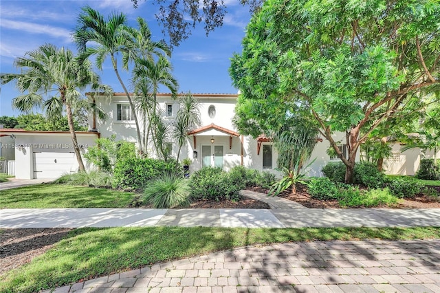 mediterranean / spanish-style house with a garage