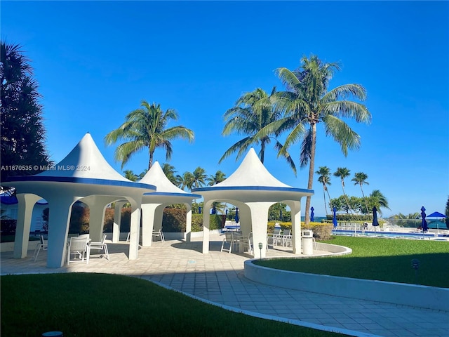 view of community featuring a yard and a patio area