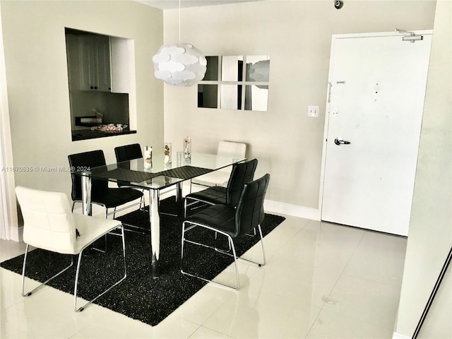 5161 Collins Ave Unit 801, Miami Beach, FL 33140 - dining room with a chandelier and tile patterned floors