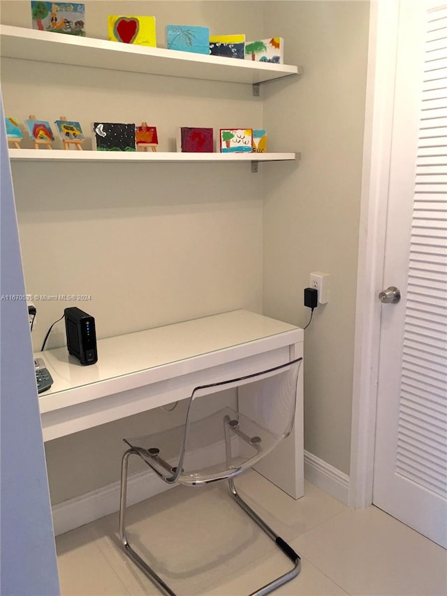 laundry room with independent washer and dryer and light tile patterned flooring