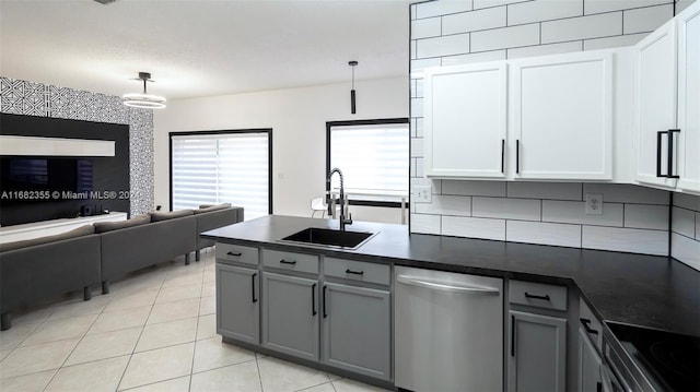 kitchen with white cabinetry, stainless steel dishwasher, pendant lighting, gray cabinetry, and sink