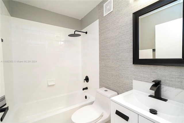 full bathroom with backsplash, toilet, tile walls, vanity, and tiled shower / bath combo