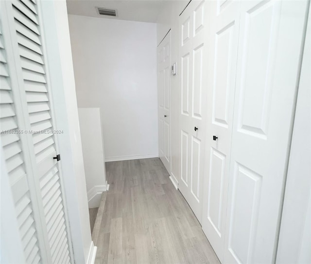 hallway with light hardwood / wood-style flooring