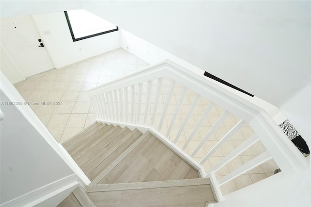 stairway featuring tile patterned flooring