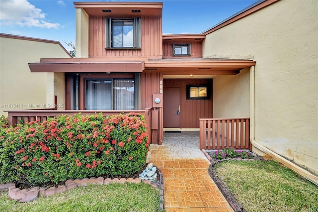 428 SE 11th Ter, Dania Beach, FL 33004 - entrance to property with covered porch, stucco siding, and board and batten siding