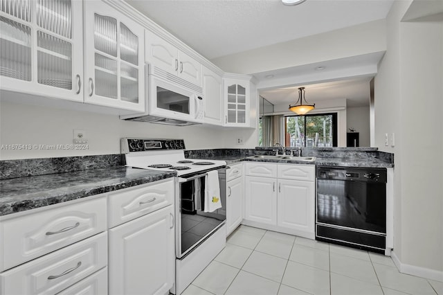 kitchen featuring sink, white cabinets, hanging light fixtures, and white appliances