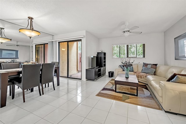 tiled living room featuring a textured ceiling and ceiling fan