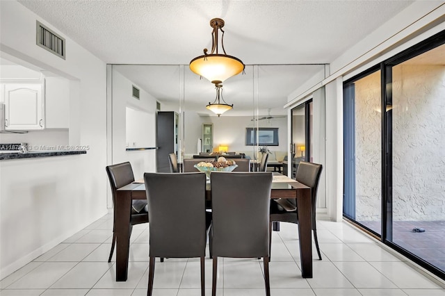 428 SE 11th Ter, Dania Beach, FL 33004 - dining space with light tile patterned floors and a textured ceiling