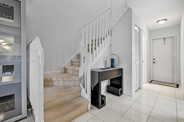 stairs with tile patterned flooring