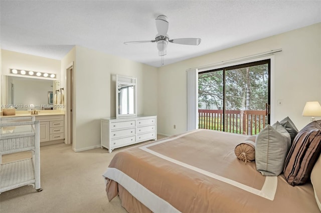 428 SE 11th Ter, Dania Beach, FL 33004 - bedroom featuring access to outside, multiple windows, light colored carpet, ensuite bathroom, and a textured ceiling