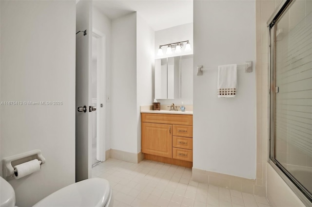428 SE 11th Ter, Dania Beach, FL 33004 - bathroom with toilet, tile patterned floors, vanity, and enclosed tub / shower combo