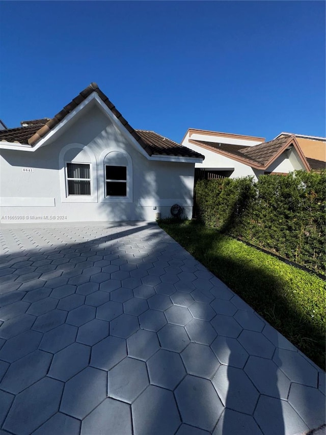 view of side of home with a patio area