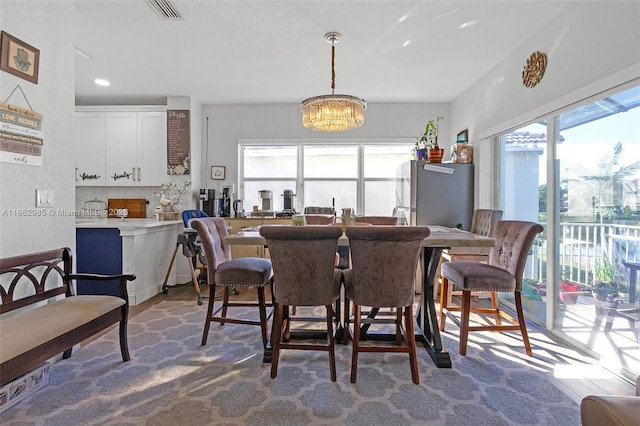 dining room featuring an inviting chandelier and hardwood / wood-style floors