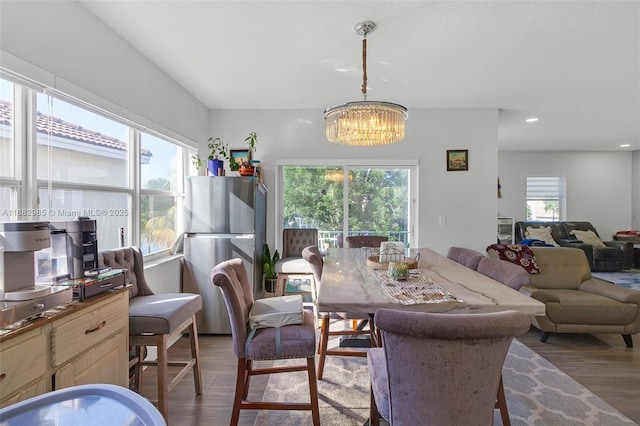 dining room featuring an inviting chandelier and dark hardwood / wood-style flooring