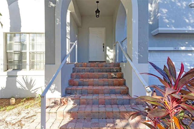 doorway to property with a garage