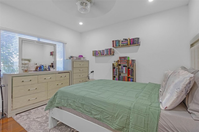 bedroom with ceiling fan and light hardwood / wood-style flooring