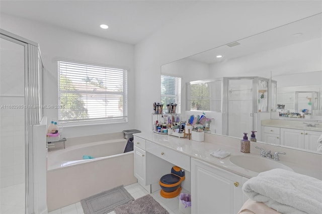 bathroom with vanity, tile patterned floors, and plus walk in shower