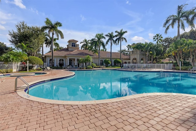 view of pool featuring a hot tub and a patio