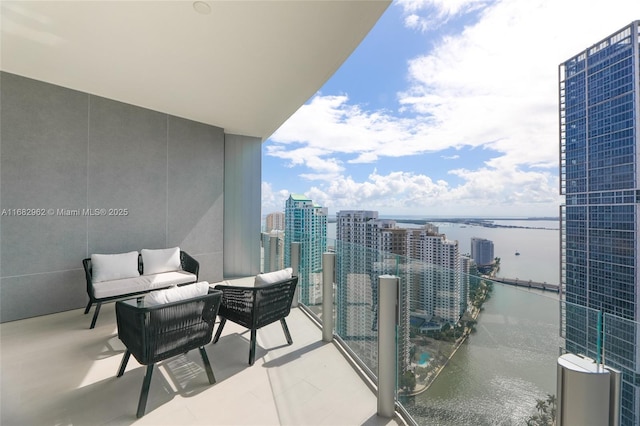 balcony featuring a water view and an outdoor hangout area