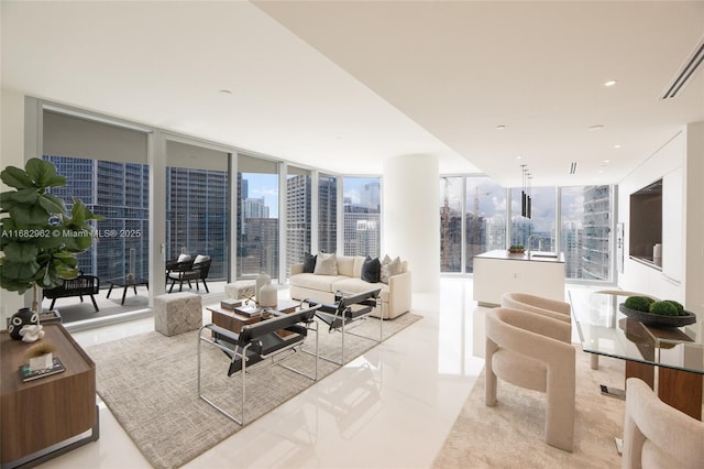 living room with a wall of windows and light tile patterned floors