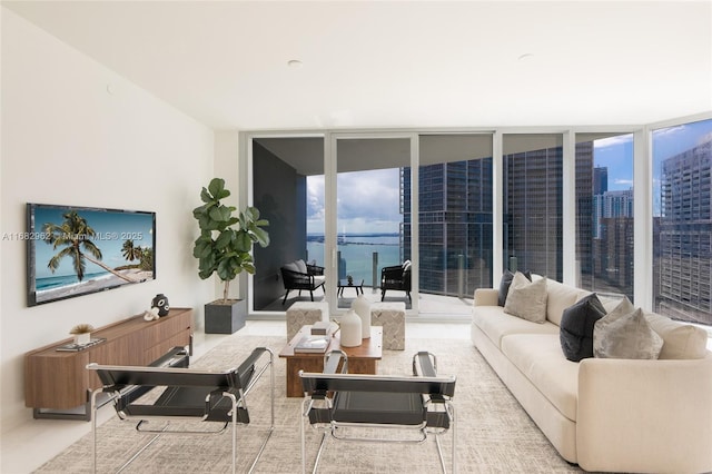 living room with a water view and a wall of windows