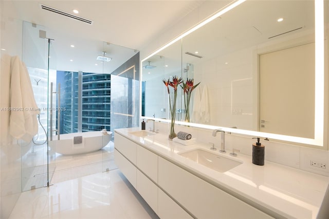 bathroom with vanity and independent shower and bath