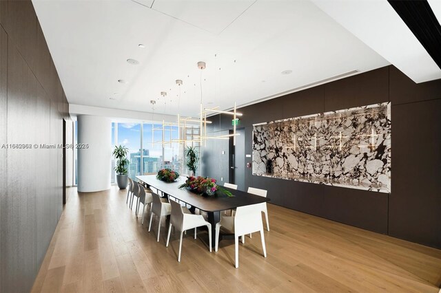 dining space with light hardwood / wood-style flooring and expansive windows