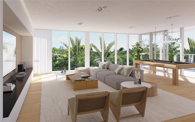 living room with light wood-type flooring, a wall of windows, and billiards