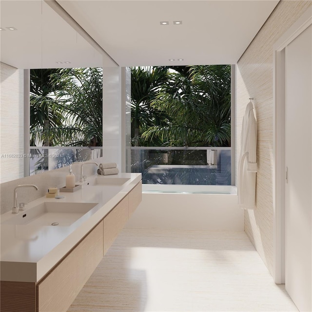 bathroom featuring a tub to relax in, vanity, and floor to ceiling windows