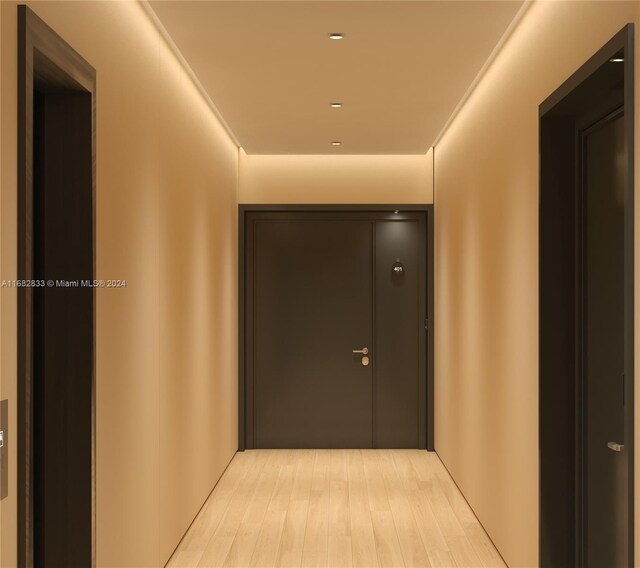 hallway with light hardwood / wood-style floors