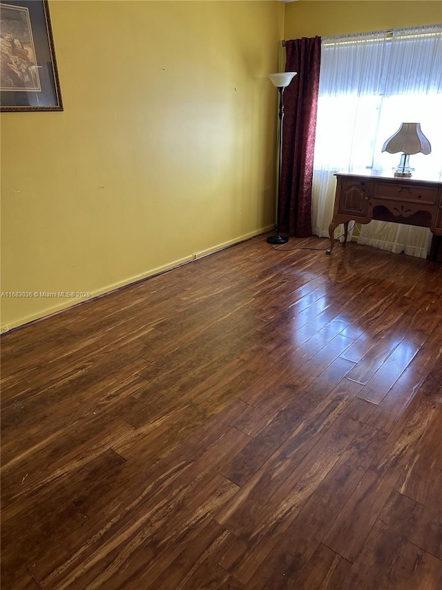 4103 Newport U Unit 4103, Deerfield Beach, FL 33442 - empty room featuring dark wood-style flooring and baseboards