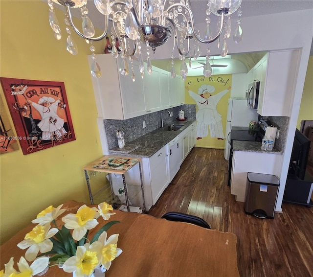 4103 Newport U Unit 4103, Deerfield Beach, FL 33442 - kitchen featuring a chandelier, a sink, white cabinetry, and appliances with stainless steel finishes