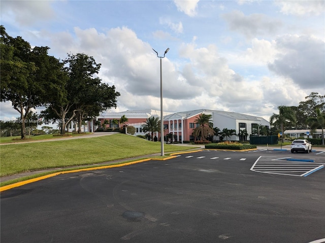 view of parking with a lawn