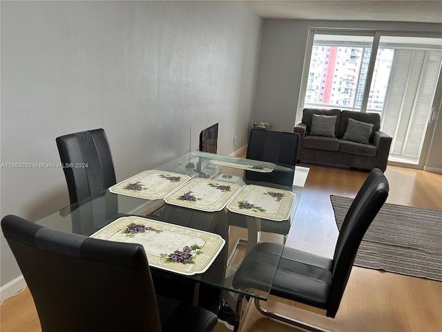 dining space with hardwood / wood-style floors