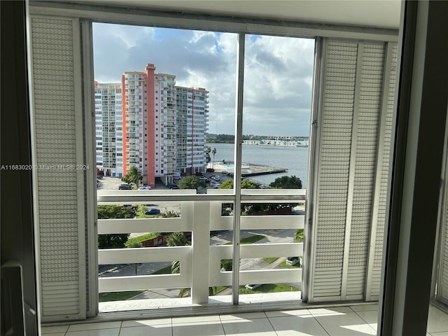 interior space with a water view and light tile patterned floors