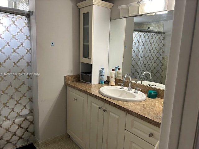 bathroom featuring vanity and a shower with shower curtain