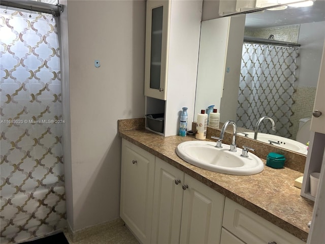 bathroom featuring vanity and curtained shower