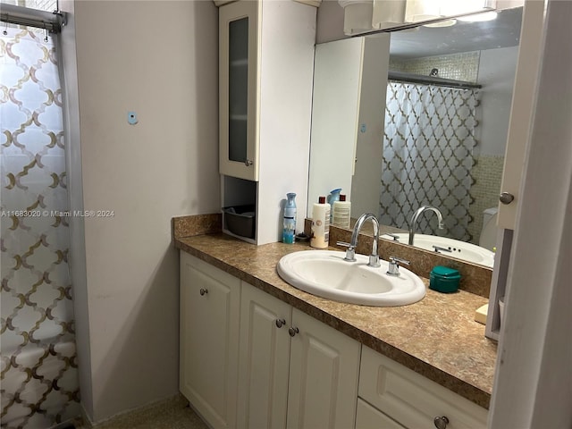 bathroom with vanity and walk in shower