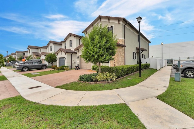 view of front of home with a garage and a front yard