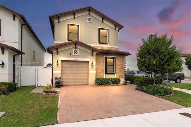 front of property featuring a garage and a yard