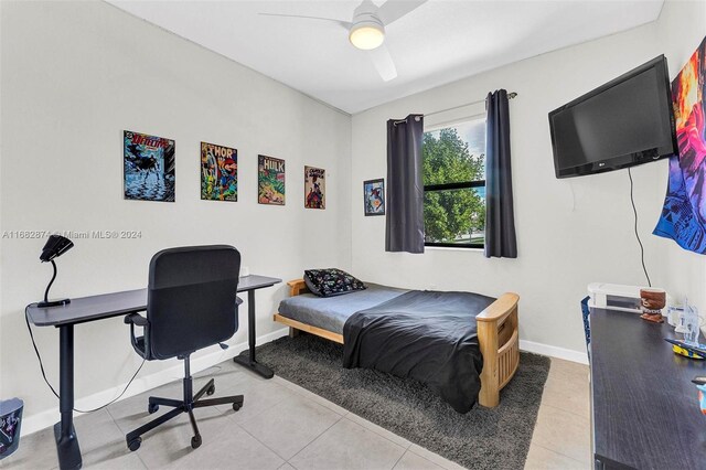 bedroom featuring light tile patterned floors and ceiling fan