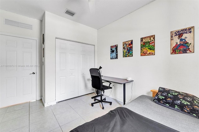 tiled bedroom featuring a closet and ceiling fan