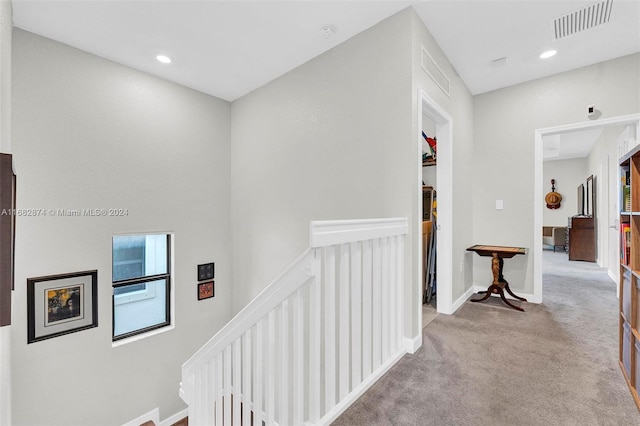 hallway featuring light carpet