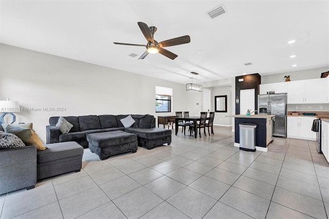 living room with light tile patterned flooring and ceiling fan