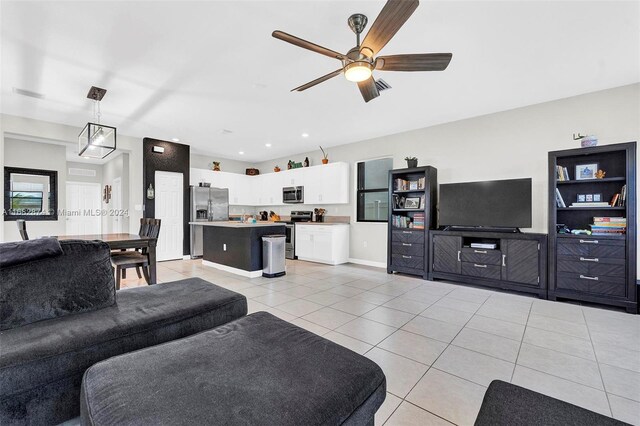 living room featuring light tile patterned floors and ceiling fan