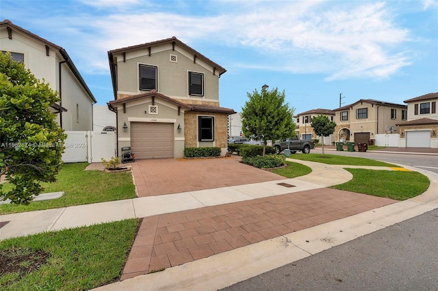 view of front property featuring a garage and a front lawn