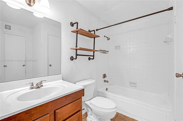 full bath with visible vents, vanity, a textured wall, toilet, and shower / bath combination